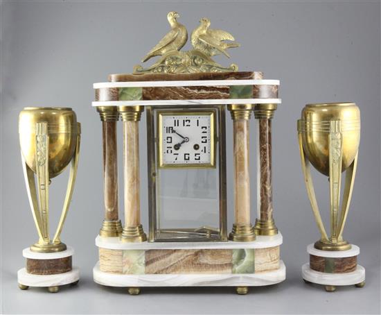 Louis Carvin. An Art Deco bronze and marble clock garniture, clock 21in.
